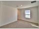 Spacious carpeted bonus room with a window and neutral color scheme at 752 Reggie Rd, Winter Haven, FL 33884