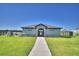 The community clubhouse features manicured landscaping, gated entry, and sidewalks at 752 Reggie Rd, Winter Haven, FL 33884