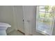 Entryway features a white front door, window with blinds, and tile flooring at 752 Reggie Rd, Winter Haven, FL 33884