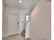Bright foyer with tile flooring, white trim, and staircase to the upper level offers a welcoming entrance at 752 Reggie Rd, Winter Haven, FL 33884