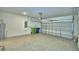 Spacious garage with speckled floor, electric door and some storage at 752 Reggie Rd, Winter Haven, FL 33884