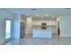Well-lit kitchen with stainless steel appliances, including a refrigerator and oven, and a center island with a sink at 752 Reggie Rd, Winter Haven, FL 33884
