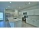 Bright kitchen features white cabinetry, stainless appliances, and a large center island with a sink at 752 Reggie Rd, Winter Haven, FL 33884