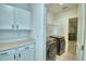 Functional laundry room with modern washer and dryer units, storage cabinets, and ample counter space at 752 Reggie Rd, Winter Haven, FL 33884