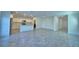 Expansive living area with tile flooring and ample natural light leads to a modern kitchen with white cabinets at 752 Reggie Rd, Winter Haven, FL 33884