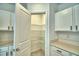 Walk-in pantry offering ample storage space with shelving and countertops, adjacent to the kitchen area at 752 Reggie Rd, Winter Haven, FL 33884