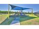 Community playground with colorful equipment and protective shade canopy at 752 Reggie Rd, Winter Haven, FL 33884