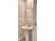 Simple powder room featuring a pedestal sink, mirror, and neutral walls, conveniently located on the main floor at 752 Reggie Rd, Winter Haven, FL 33884