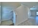 Carpeted staircase leads to a room with tile flooring and white walls at 752 Reggie Rd, Winter Haven, FL 33884