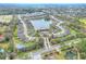 Wide aerial view of the residential community with a central lake and clubhouse with a pool at 7779 Lake James Blvd, Lakeland, FL 33810