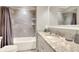 Bright bathroom featuring tiled walls, a vanity with a granite countertop, and a shower with a curtain at 7779 Lake James Blvd, Lakeland, FL 33810