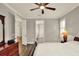 Bedroom with neutral tones, ceiling fan, and ensuite access at 7779 Lake James Blvd, Lakeland, FL 33810
