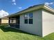 Exterior view of the home with a screened lanai and well-kept lawn at 7779 Lake James Blvd, Lakeland, FL 33810