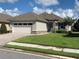 Beautiful single-story home featuring a spacious driveway, stone accents and well-maintained landscaping at 7779 Lake James Blvd, Lakeland, FL 33810