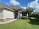 Charming single-story home with stone accents, manicured lawn, and a welcoming blue front door at 7779 Lake James Blvd, Lakeland, FL 33810