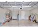 Garage interior with epoxy flooring, storage shelves, water heater and ample storage space at 7779 Lake James Blvd, Lakeland, FL 33810