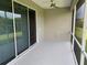 Screened lanai with a ceiling fan and sliding glass doors, offering seamless indoor-outdoor living at 7779 Lake James Blvd, Lakeland, FL 33810