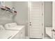 A laundry room with a washer, dryer, wire rack shelving and a door at 7779 Lake James Blvd, Lakeland, FL 33810