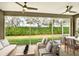 Screened-in patio with comfortable seating and view of the landscaped backyard at 7779 Lake James Blvd, Lakeland, FL 33810