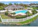 Community pool area featuring a large pool, white pergola, fencing, and landscaping at 7779 Lake James Blvd, Lakeland, FL 33810