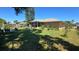 Backyard featuring a well-maintained lawn and screened in porch at 7818 Lewis Rd, Lakeland, FL 33810