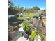 Spacious backyard with a mix of grassy areas and landscaping, offering potential for gardening or outdoor living at 7818 Lewis Rd, Lakeland, FL 33810