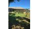 Well-maintained backyard featuring a covered patio, mature landscaping, and ample green space for outdoor activities at 7818 Lewis Rd, Lakeland, FL 33810