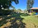 Well maintained backyard with large shade tree and lawn at 7818 Lewis Rd, Lakeland, FL 33810