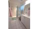 Well-lit bathroom with a shower, vanity, and tiled floor creating a clean and functional space at 7818 Lewis Rd, Lakeland, FL 33810