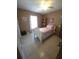 Bedroom featuring tile floor, decorative curtains, and a ceiling fan at 7818 Lewis Rd, Lakeland, FL 33810