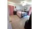 Inviting bedroom with tile flooring, natural light, and neutral décor, offering a serene and comfortable space at 7818 Lewis Rd, Lakeland, FL 33810