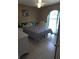 This bedroom features neutral walls, a window, and tile floors at 7818 Lewis Rd, Lakeland, FL 33810