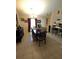Inviting dining area with tile floors, chandelier, and adjacent kitchen at 7818 Lewis Rd, Lakeland, FL 33810