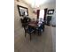 A well-lit dining room with neutral tile flooring and dark wood furniture at 7818 Lewis Rd, Lakeland, FL 33810