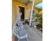 Inviting front porch featuring chairs, plants, an arched window, and a peek into the home's interior at 7818 Lewis Rd, Lakeland, FL 33810