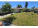 Charming single story home with well-manicured front lawn and mature landscaping at 7818 Lewis Rd, Lakeland, FL 33810