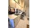 Bright kitchen with stainless steel sink, white cabinets, and tile flooring at 7818 Lewis Rd, Lakeland, FL 33810