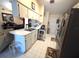 Open kitchen with white cabinetry, stainless steel appliances, and view of the dining area at 7818 Lewis Rd, Lakeland, FL 33810