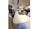Bright kitchen featuring a white countertop and stainless steel appliances at 7818 Lewis Rd, Lakeland, FL 33810
