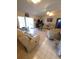 Spacious living room with tile flooring, leather seating, and sliding glass doors at 7818 Lewis Rd, Lakeland, FL 33810