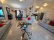 Open-concept living room and kitchen area with lots of natural light and tile flooring at 7818 Lewis Rd, Lakeland, FL 33810