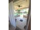 Bright sunroom featuring tiled flooring, ceiling fan, and glass windows providing views of the backyard at 7818 Lewis Rd, Lakeland, FL 33810