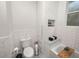 Bright white bathroom features subway tile, toilet and built-in marble countertop at 805 Johnson Ave, Lakeland, FL 33801