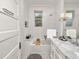 Modern bathroom with white subway tile, marble countertop, and tub with shower at 805 Johnson Ave, Lakeland, FL 33801