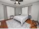 Cozy bedroom with a plush bed, gray walls, hardwood floors, and bright windows at 805 Johnson Ave, Lakeland, FL 33801