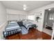 Bedroom with two beds, ceiling fan, hardwood floors and ensuite bathroom at 805 Johnson Ave, Lakeland, FL 33801