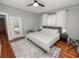 Comfortable bedroom with a large bed, hardwood floors, and natural light at 805 Johnson Ave, Lakeland, FL 33801