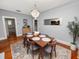 Elegant dining room featuring a modern chandelier, stylish seating, and hardwood floors at 805 Johnson Ave, Lakeland, FL 33801