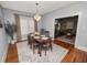 The dining room has a modern chandelier, a wood table, and hardwood floors at 805 Johnson Ave, Lakeland, FL 33801