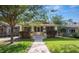 Charming bungalow-style home with a well-manicured lawn and inviting screened front porch at 805 Johnson Ave, Lakeland, FL 33801